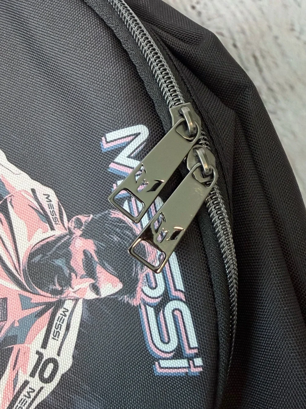 Black Messi backpack with graphic of a soccer player in action